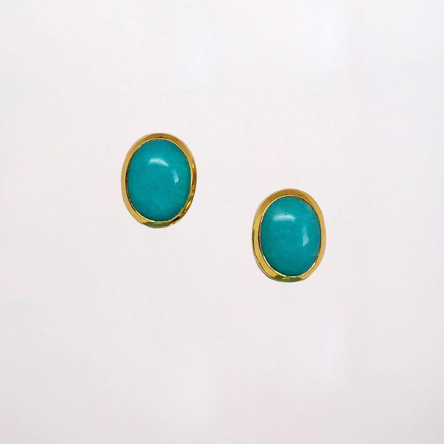 Amazonite Stud Earrings, a pair of turquoise earrings set in yellow gold on a white background