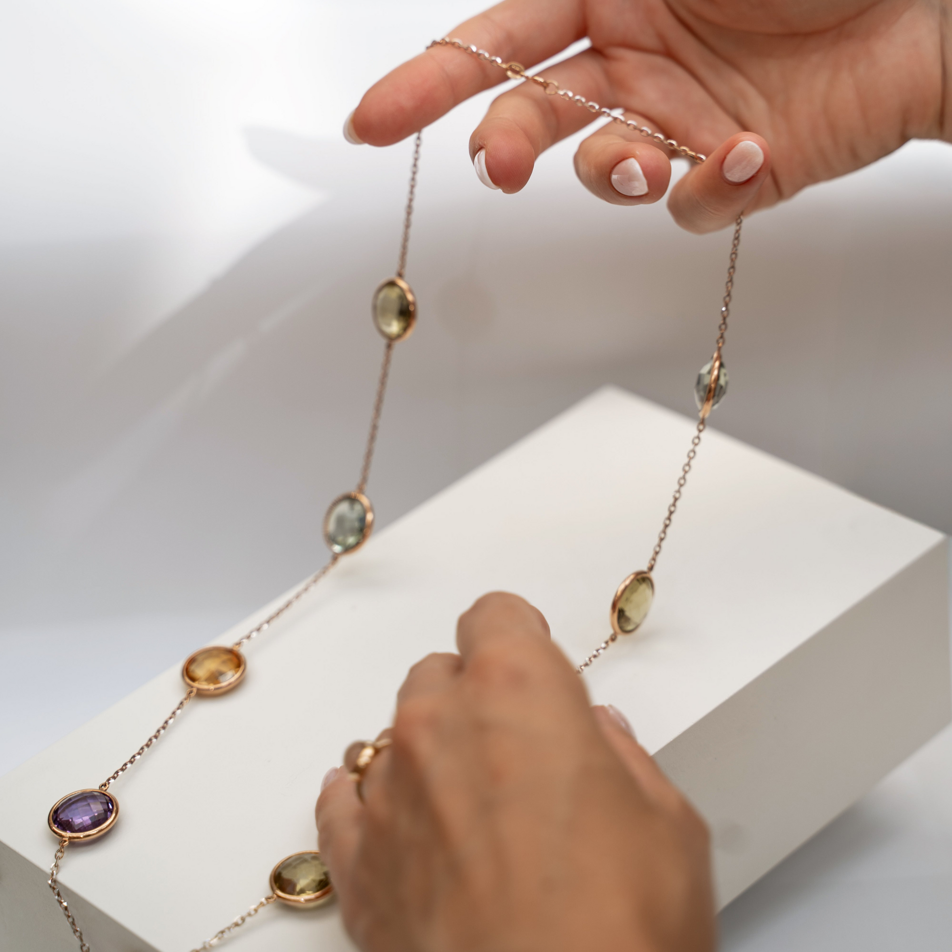 Colorful Necklace Round Gemstones set in rose gold with hand as size reference