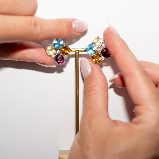 Colorful Stud Earrings Gold and hands for size reference 