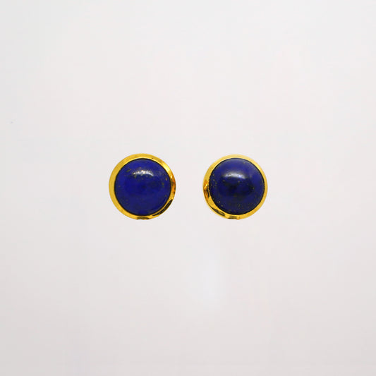 Pair of round blue lapis lazuli studs gold earrings with gold rims on a white background