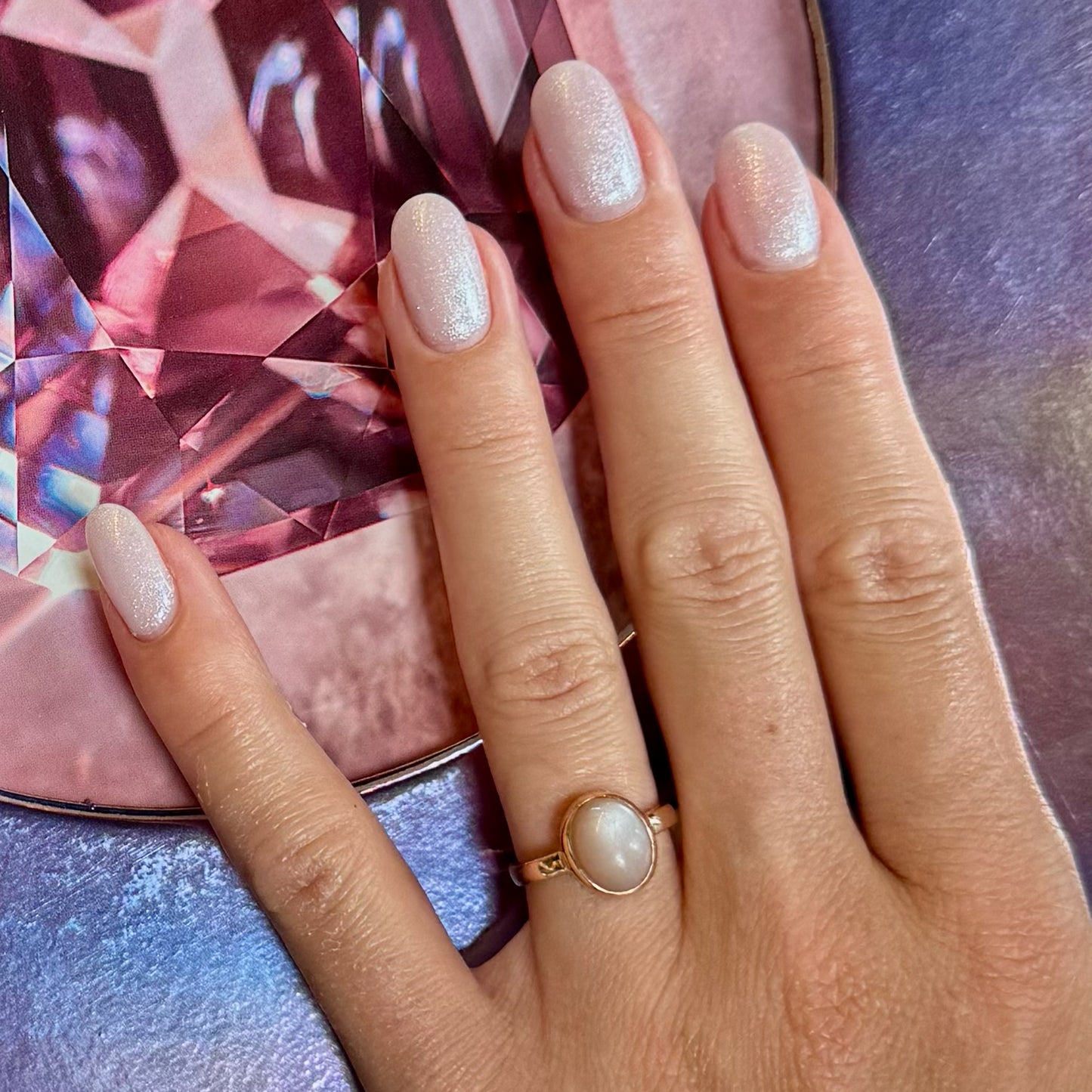 Hand with Moonstone Gold Ring in rose gold with peach moonstone