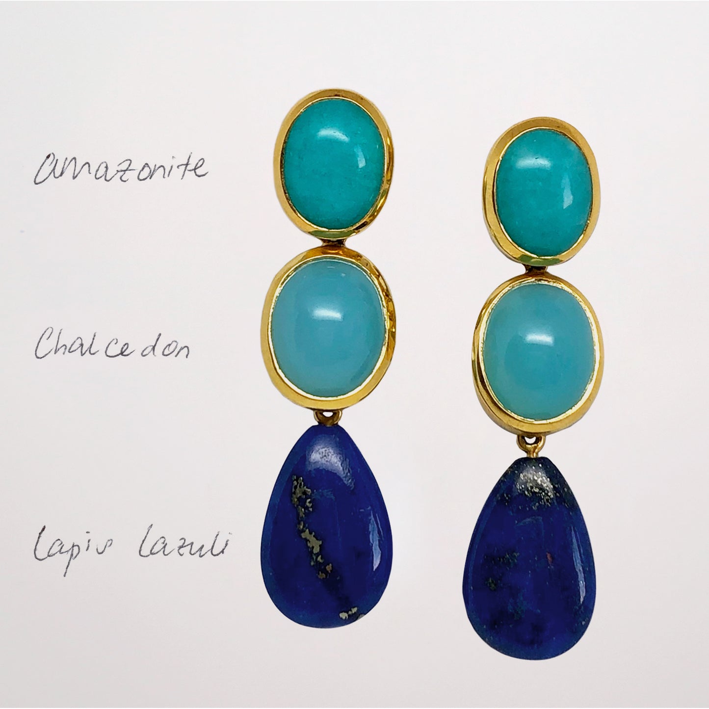 Pair of blue gemstone earrings with turquoise and blue stones on a white background with Amazonite Studs, Chalcedony and Lapis Lazuli